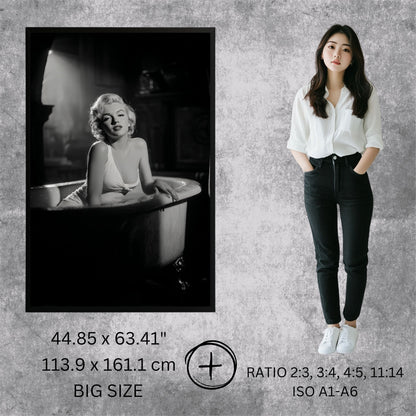 Woman standing next to a framed black and white photo of a famous actress on a textured gray wall.