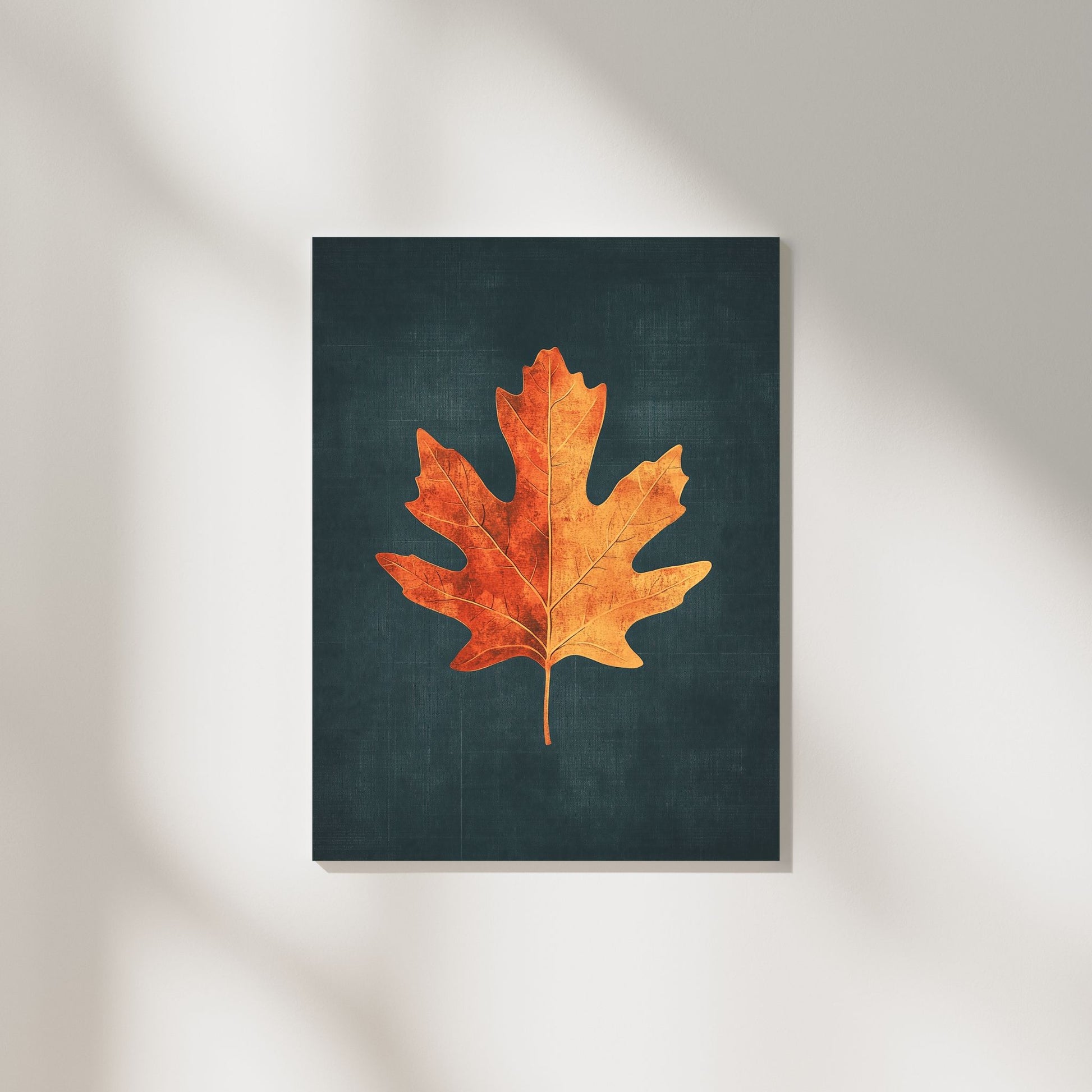 Minimalist botanical wall art featuring a golden maple leaf on a dark background