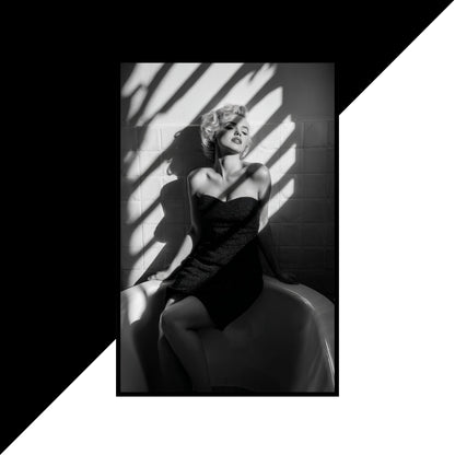 Black and white portrait of Marilyn Monroe sitting with shadows on a textured wall.