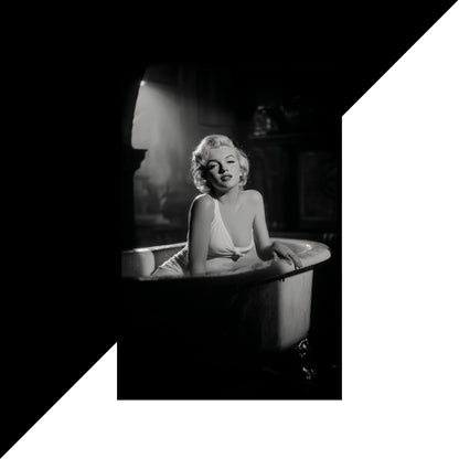 Black and white photograph of a person sitting in a bathtub