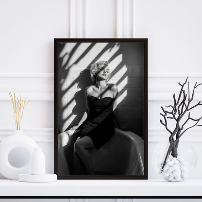 Framed black and white portrait of Marilyn Monroe on a white wall with decorative elements