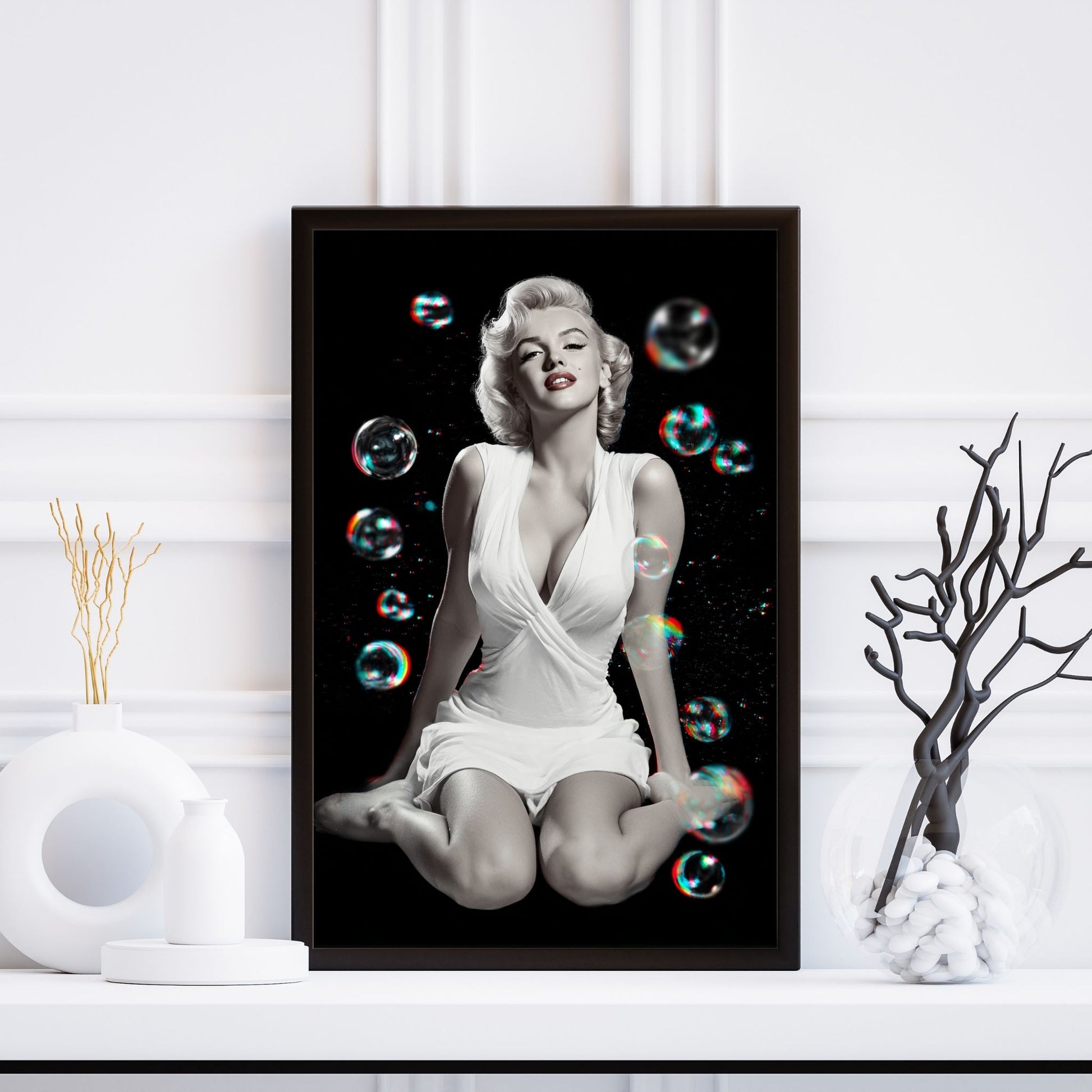 Framed poster of a woman in a white dress with bubbles on a white wall.