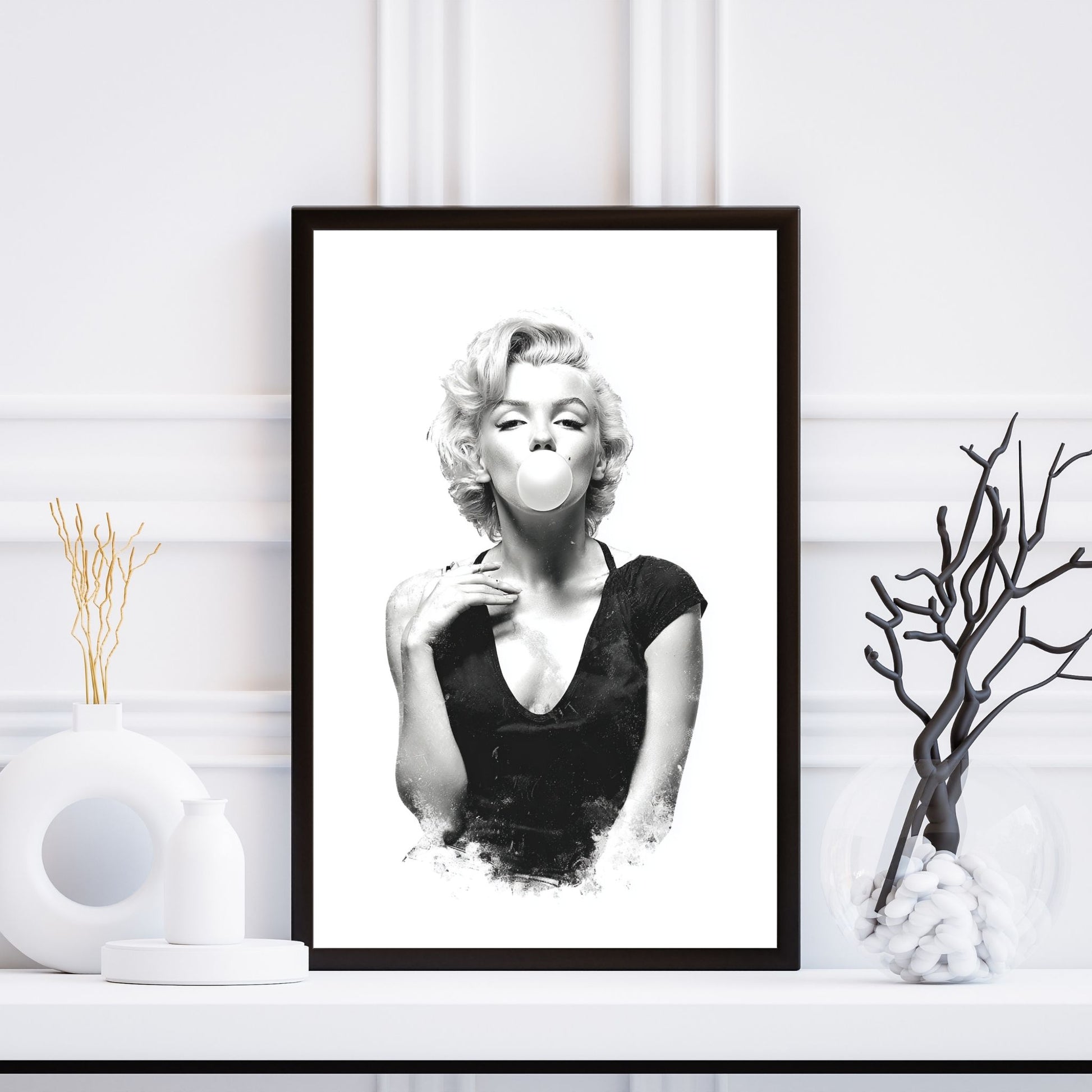 Framed black and white portrait of a famous actress on a white wall.