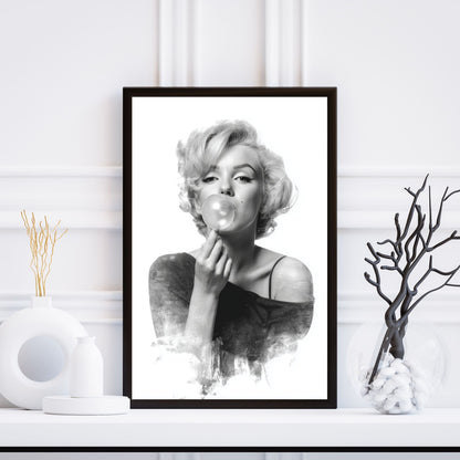 Framed black and white portrait of a woman blowing bubbles on a white wall.